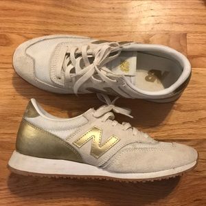 Gold new balance tennis shoes